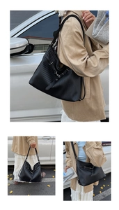 Detail of black pleated tote bag showing fine vertical pleats and slender shoulder straps