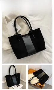 Detail of black suede and smooth leather tote bag with stylish woven cross stitching