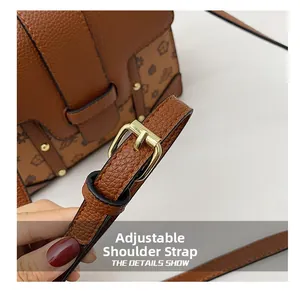 Detail of the adjustable brown leather strap with polished gold-tone metal buckle