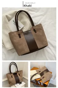 Detail of khaki suede and dark brown leather stitching on vintage tote bag with weaving