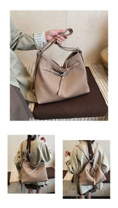 Detail of beige pleated tote bag showing versatile hand-carry and shoulder-wear styles