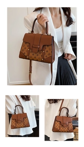 Close-up of brown monogram crossbody bag with vintage patterns and gold rivet details