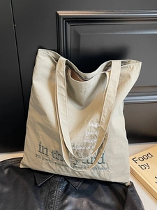 Large beige canvas tote bag with nature-themed embroidery for commuting and school