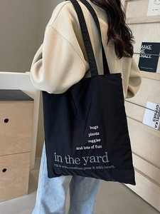Large black canvas tote bag for women with 'in the yard' print for school and commute