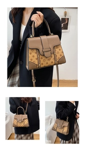 Detail of vintage embossed crossbody bag with monogram pattern and gold hardware