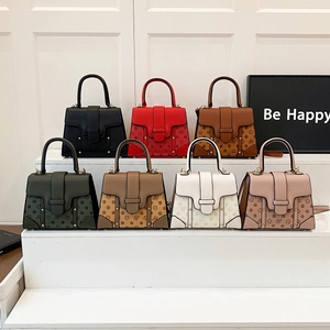 Detail showing vintage textured leather handbags with floral bee embossing in seven colors