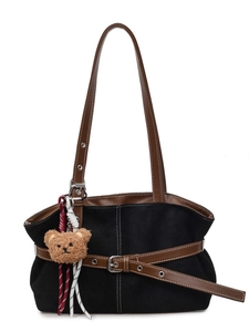 Black suede tote bag with brown leather straps, decorative belt, and plush bear charm