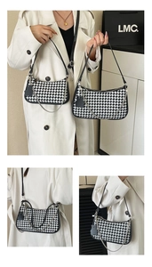 Detail of checkered hobo bag with adjustable strap and decorative metal chain