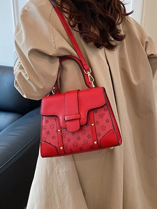 Vintage red monogram handbag with gold rivets and leather crossbody strap for women