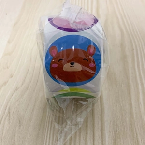 Detail of cartoon bear reward stickers roll in protective plastic bag packaging