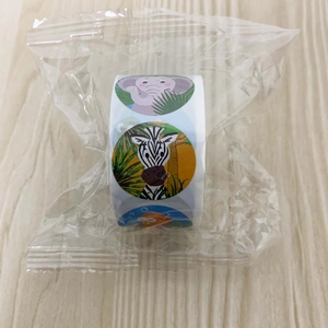 Roll of cartoon animal stickers with elephant and zebra patterns in clear plastic bag