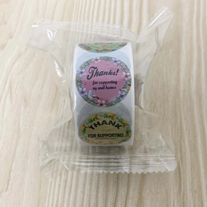 Macro view of floral thank you stickers roll for small business packaging