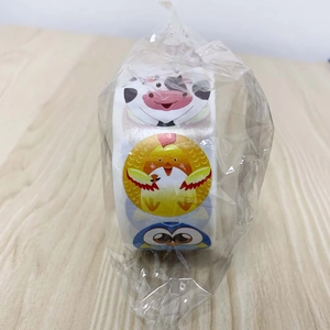 Detail of cartoon animal reward stickers roll with cow and owl designs for kids