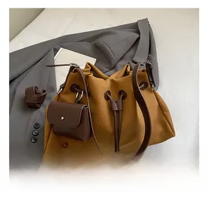Close-up of vintage brown suede bucket bag with drawstring and leather strap