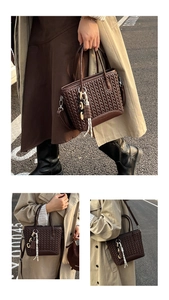 Detail of dark brown quilted handbag with chic ribbon and chocolate charm in outdoor setting