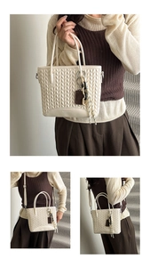 Detailed view of cream quilted bucket bag with stitching pattern and crossbody strap