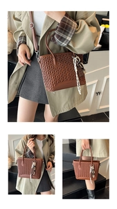 Detailed V-shaped woven texture on brown tote bag with chain strap and chocolate charm