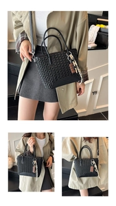 Detail of black woven tote bag with herringbone texture and cute chocolate charm pendant