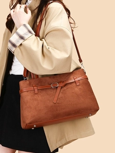 Brown vintage suede tote bag with metal buckles and long shoulder straps for daily use