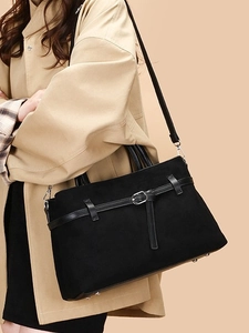 Fashionable black faux suede large tote bag with polished leather straps and buckles
