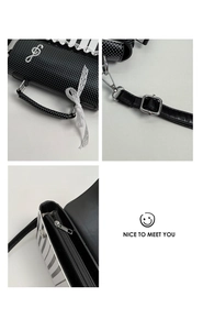Detail view of musical note charms, polka dot handles and metal zippers on a piano style bag