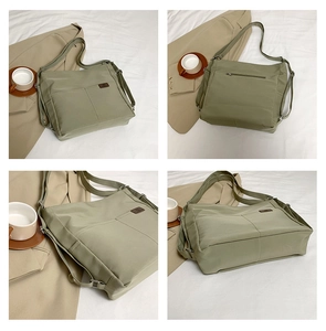 Detail view of water-resistant green nylon multi-way bag showing pockets and strap