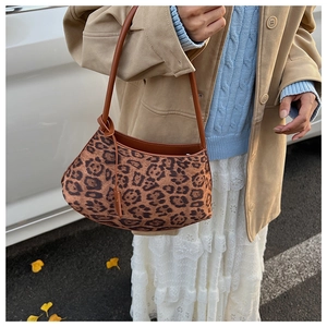 Close-up of leopard print hobo shoulder bag with brown leather strap and knot detail