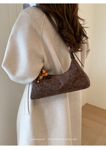 Braune Baguette-Tasche mit Leopardenmuster und Perlenanhänger am Mantel