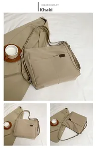 Detail of khaki waterproof nylon tote bag with brown leather logo and adjustable strap