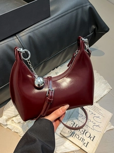 Retro burgundy crescent shoulder bag in glossy leather with silver ball chain accessory
