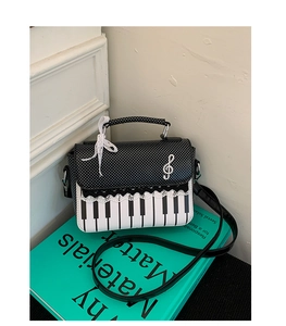 Macro detail of piano keyboard pattern with lace trim and silver treble clef charm