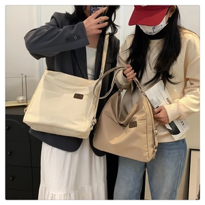 Detail of waterproof nylon crossbody bags in beige and khaki with adjustable shoulder straps