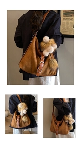 Detail view of woven brown tote bag with plush charm and stylish strap buckles