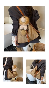 Detail view of khaki woven tote bag with brown straps and cute plush pendant charm