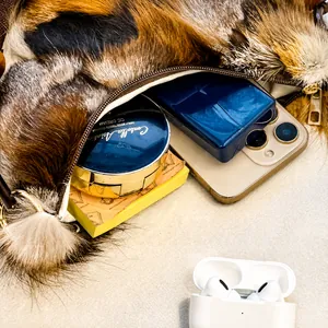 Detail view of the large capacity interior of the faux fur shoulder bag with zipper closure