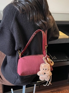 Chic burgundy suede cylinder shoulder bag with cute plush puppy charm and gold hardware