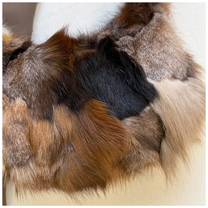 Detailed close-up of multi-color patchwork fox fur texture on the vintage shoulder bag