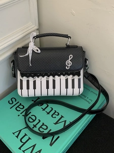 Chic piano keyboard pattern handbag with polka dot flap and musical note detail