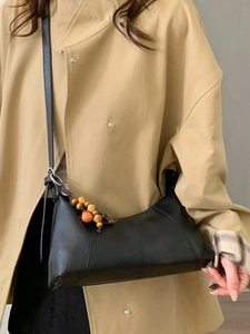 Elegant black faux leather baguette bag with vintage wooden beads and shoulder strap