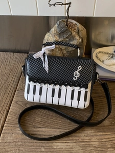Fashionable piano themed crossbody bag with polka dots and musical note pattern