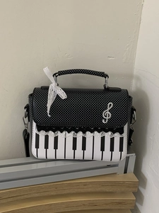 Fashionable black and white piano key handbag with polka dots and lace bow detail