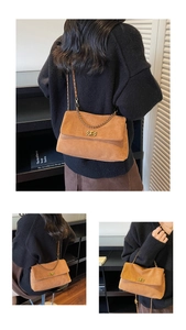 Detail of brown leopard style suede shoulder bag with gold chain strap and metal lock