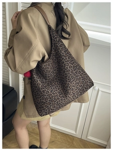Leopard print tote bag worn on shoulder showing large capacity and retro chic style