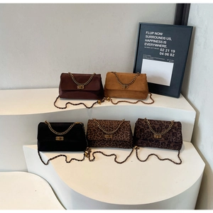 Selection of baguette bags in solid suede and leopard prints with gold chain handles