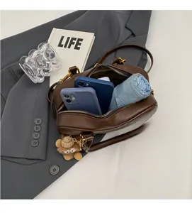 Vue de dessus de l'intérieur spacieux d'un sac polochon en cuir marron avec parapluie