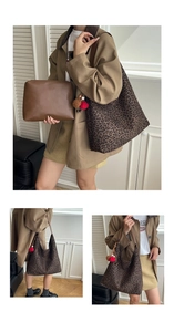 Detail view of a large leopard print tote bag with brown straps and pompom charm set