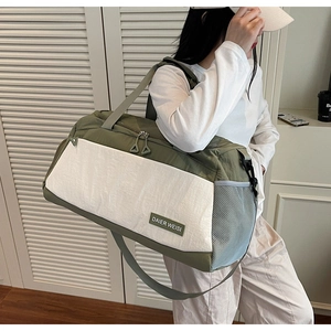 Detail of army green and beige travel bag with side mesh pocket and adjustable strap