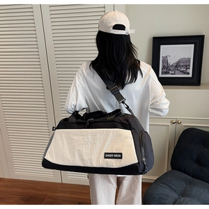 Close-up of durable black and white sports gym bag with adjustable shoulder straps