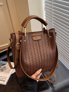 Brown woven PU leather tote bag with sturdy handles and adjustable shoulder strap