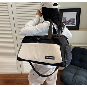 Detail of multi-pocket travel duffel bag with durable nylon and adjustable shoulder strap